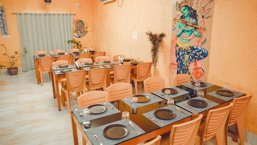 image of the fine dining restaurant at dip holidays at birbhum featuring an orange coloured interior