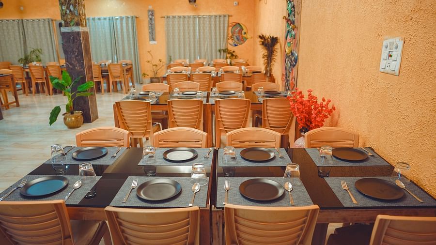 image featuring an eight seater dining table at mache vate banagali restaurant at dip holidays, birbhum 
