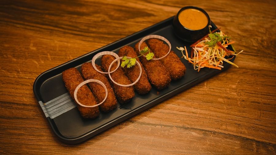 image of indian fritters topped with onion rings served with a dip along with some salad on the side - Dip Holidays, Birbhum