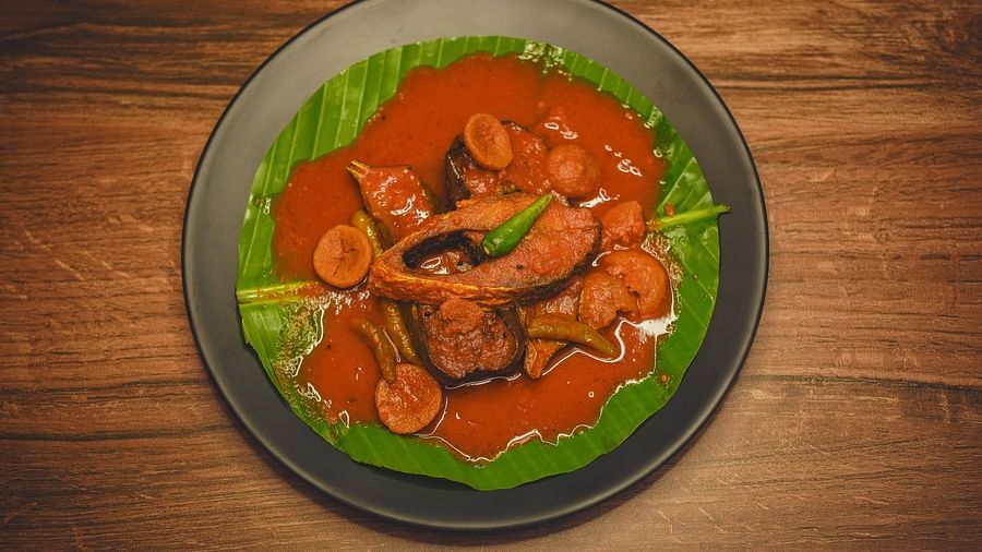 image featuring a bengali style fish curry preparation topped with a sliced green chilli - Dip Holidays, Birbhum