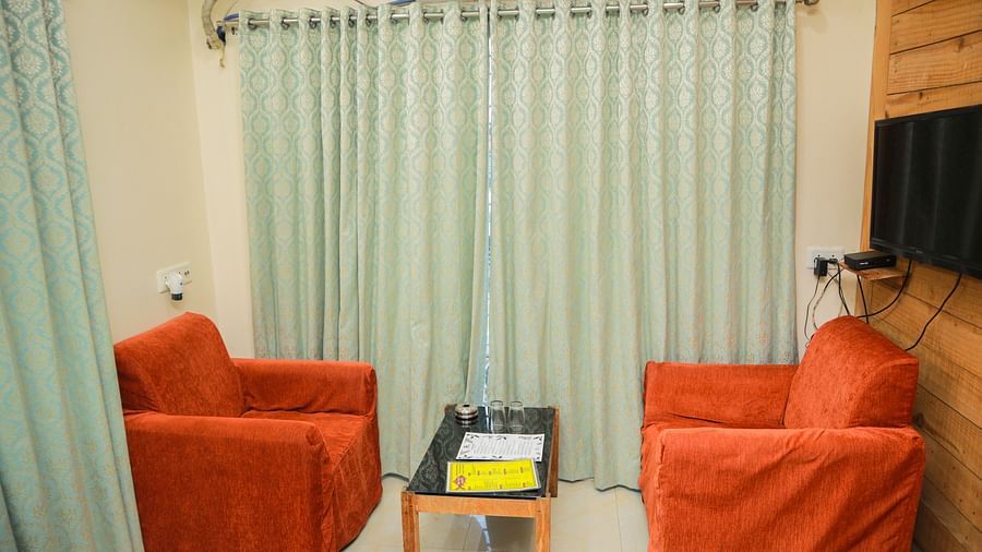 image featuring a common seating area with crimmison coloured cushioned chairs with a centre table in the middle