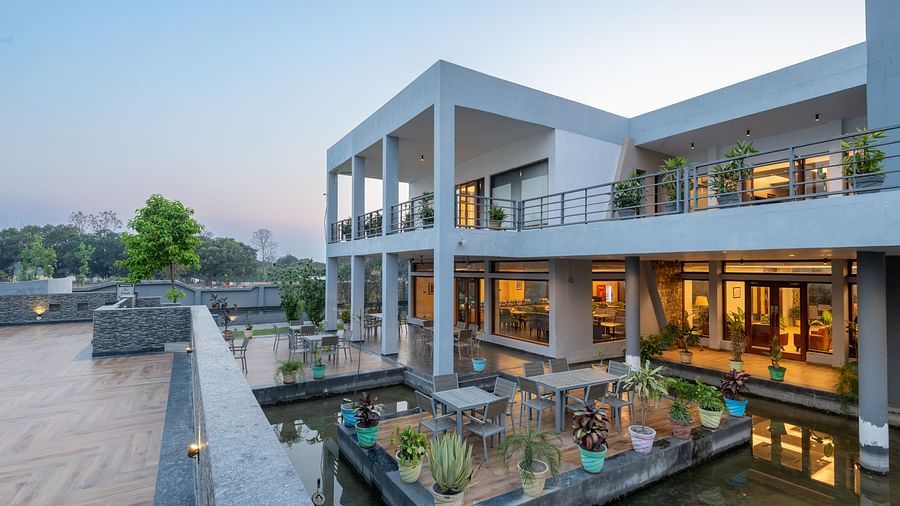 DLS Forest Vines Resorts facade bathed in the soft glow of warm lights from its windows and doors.