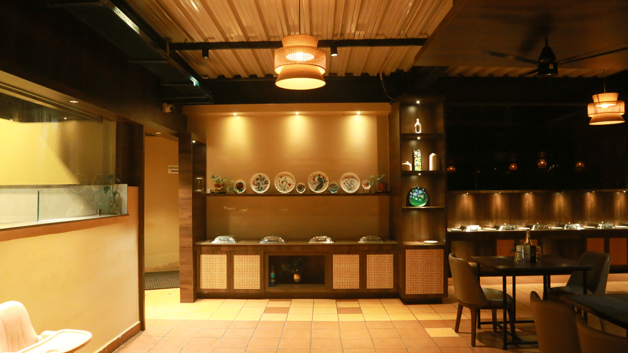 A clean and modern buffet area at DNC Shevaroys Resort & Spa with wooden cabinetry and recessed warm lighting.