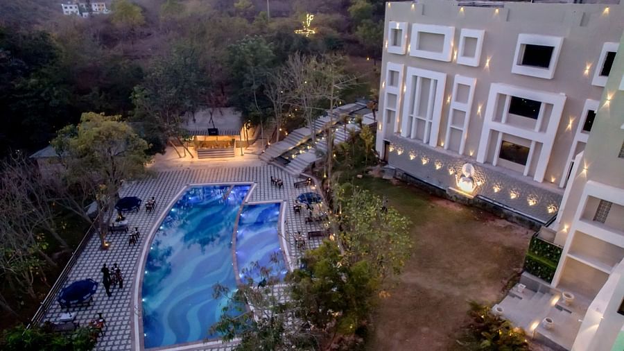 Aerial view of the swimming pool at Essentia Luxury Resort & Spa, Udaipur.