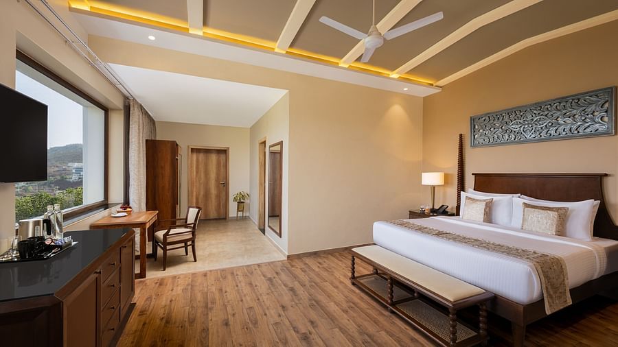 Executive Suite Room with double beds placed in front of TV at Essentia Luxury Resort & Spa, Udaipur.
