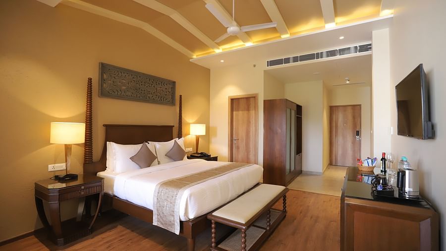 Executive Suite Room with double beds placed in front of TV at Essentia Luxury Resort & Spa, Udaipur.