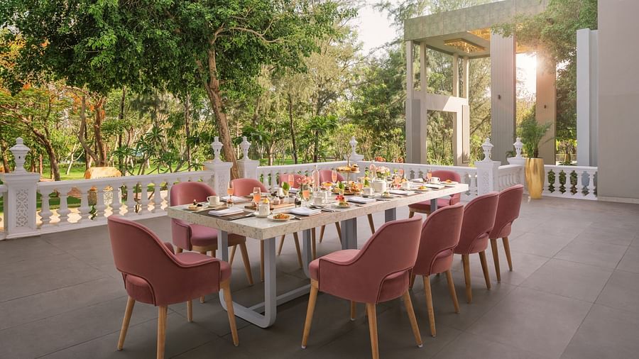 An elegant dining setting placed outdoors at Essentia Luxury Resort & Spa, Udaipur. 