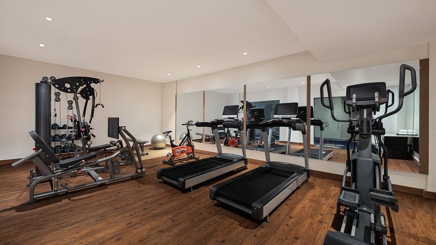 A gym equipped with gym facilities at Essentia Luxury Resort & Spa, Udaipur.