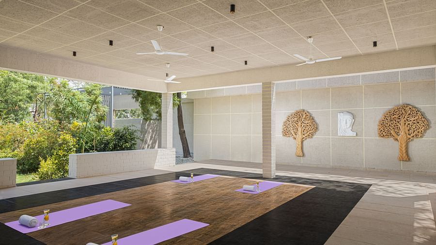 An elegant placement of yoga mats and lemonade in a room at Essentia Luxury Resort & Spa, Udaipur.