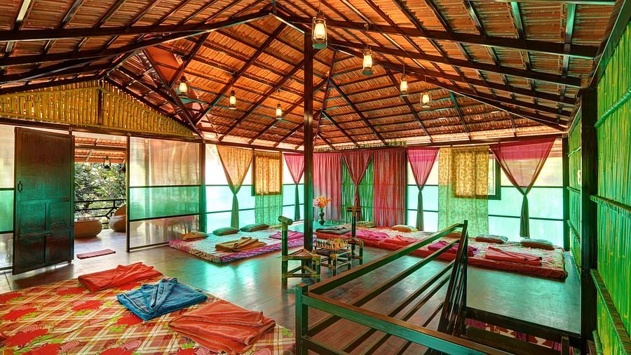A view of the attic in Wooden Cottage with comfortable beds and a high ceiling - Evergreen County