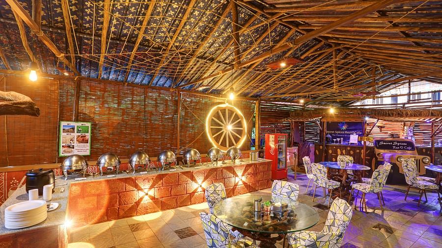 Interior of a rustic restaurant with a buffet setup and decorative bamboo roofing - Evergreen County