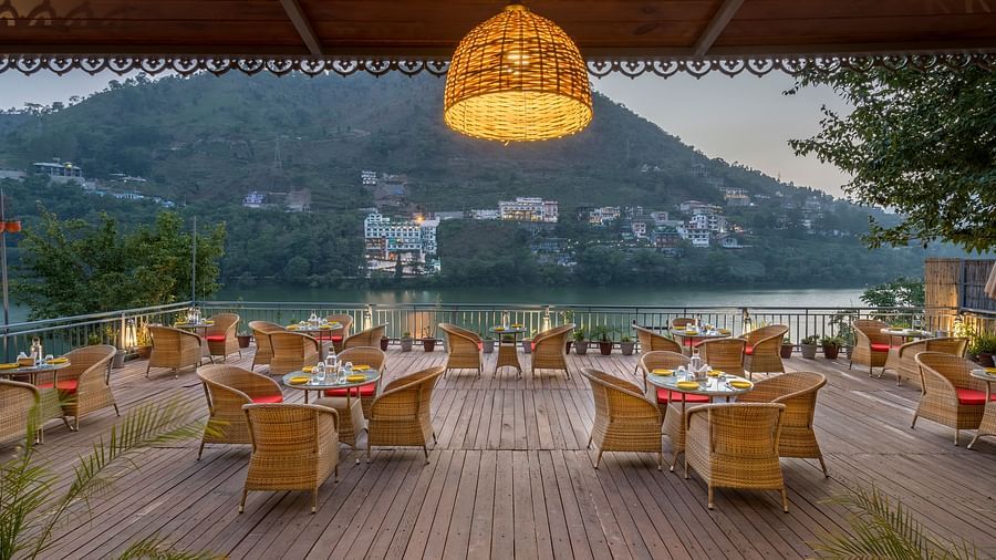 Wide angle shot of L-attitude deck with a beautiful lake and mountain view at Fishermen's Lodge, Bhimtal 