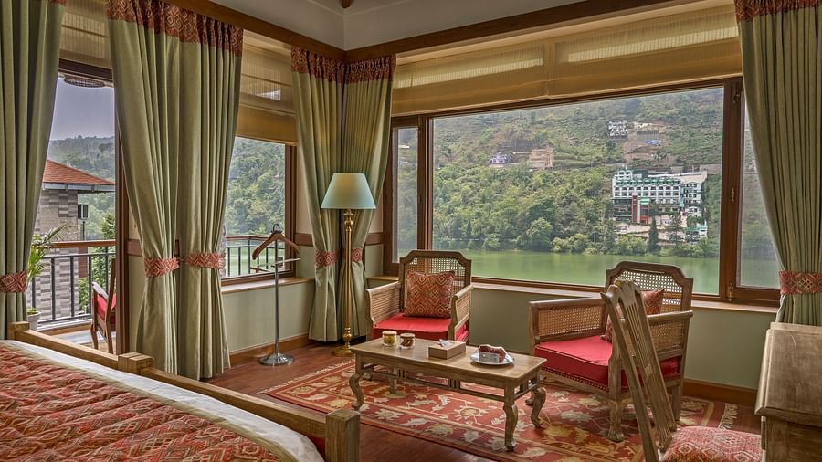 A cozy and royal sitting area in the Superior Lake Facing Rooms at Fishermen's Lodge, Bhimtal, offering stunning views of the lake.