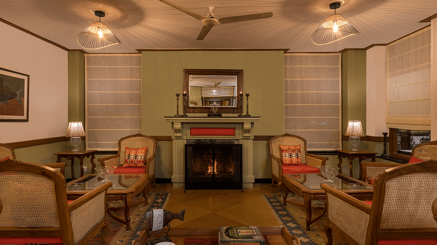 Elegant living room showcasing a plush sofa, a warm fireplace, and ornate ceilings, creating a royal and luxurious atmosphere.-Fishermen’s Lodge