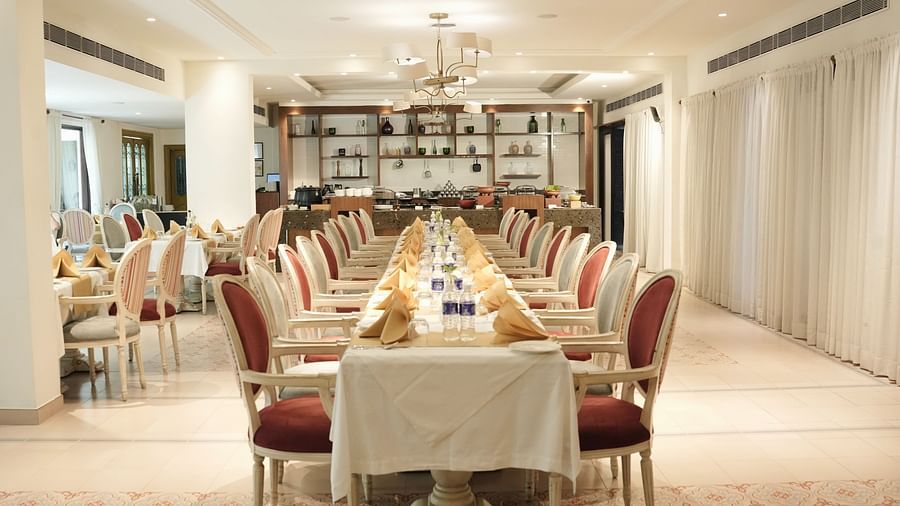 Fine dining area with numerous chairs and tables set and ready for guests.
