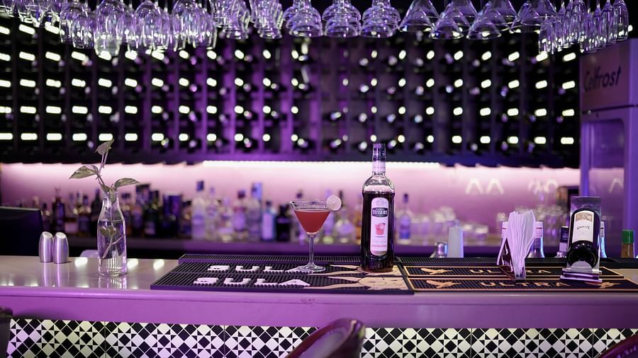 Bar area with chairs and a well-stocked bar set up, ready for an enjoyable evening