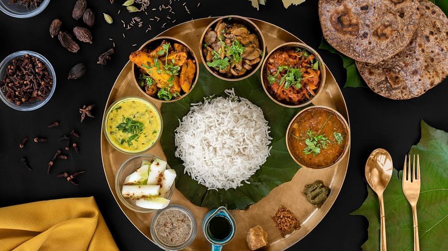  A traditional Indian thali, featuring a variety of vegetarian and non-vegetarian dishes.