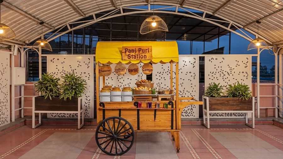 A colorful food cart serving freshly prepared Indian street food.