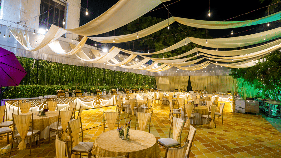 Lawn of Gemini Continental featuring banquet tables, elegant drapes, and a long buffet line under warm festive lighting.