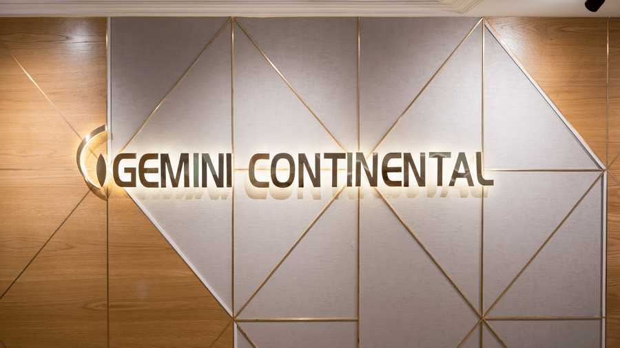 An accent wall with geometrical patterns in dual tone and the words 'Gemini Continental'.