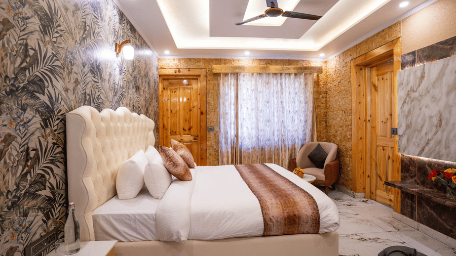Close-up of an elegant bedroom with a tufted headboard, patterned wallpaper, and warm lighting - Golden Oak By The Lake Hill, Khurpatal