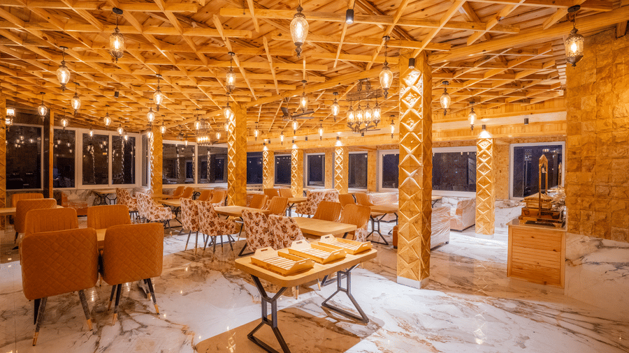 The main dining room showing a buffet setup and wide windows overlooking the hills - Golden Oak By The Lake Hill, Khurpatal