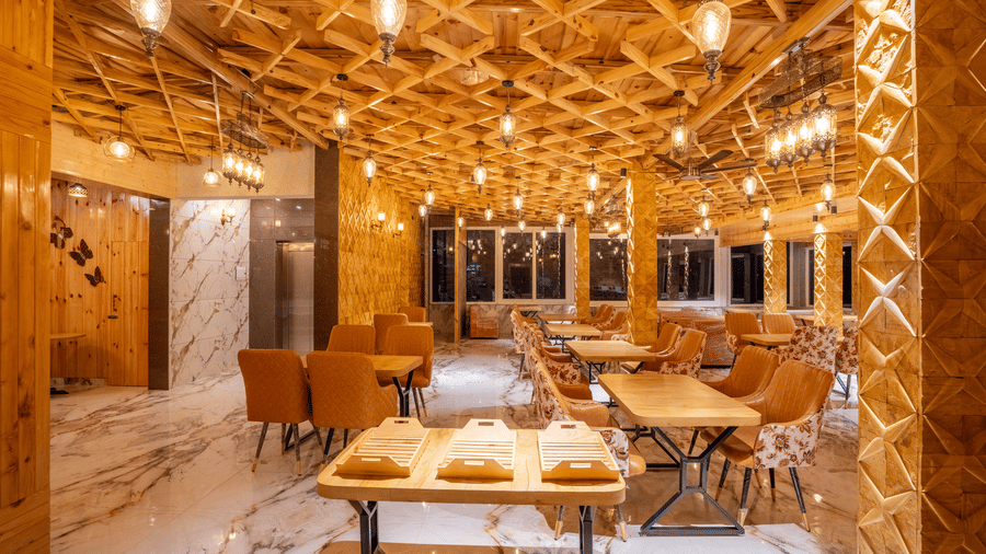 An upscale hotel restaurant featuring high-end wood finishes and a bright, inviting atmosphere - Golden Oak By The Lake Hill, Khurpatal