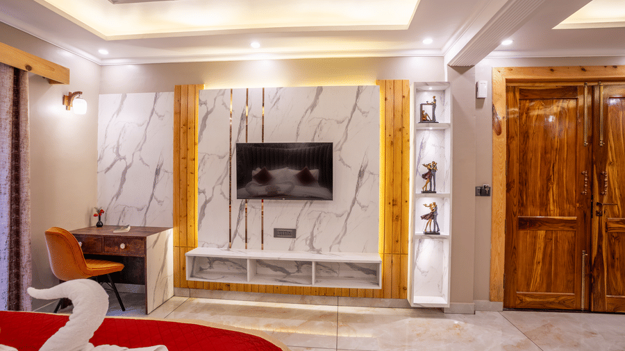 A modern TV wall unit with marble textures and an adjacent wooden work desk and chair - Golden Oak By The Lake Hill, Khurpatal