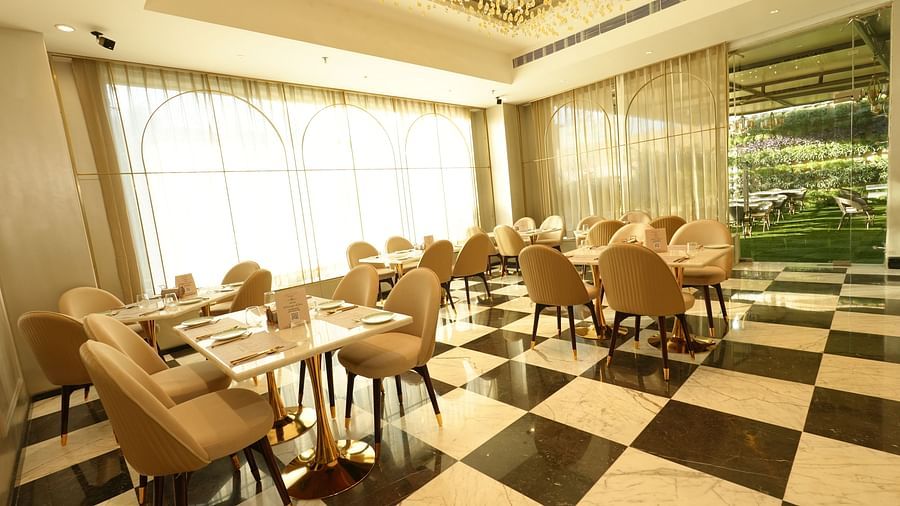 Restaurant space with natural lighting and checkered flooring - Grand Plaza Lords Inn Jammu