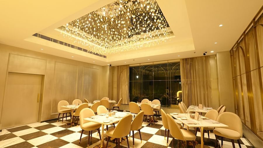 Chic restaurant interior with patterned flooring and hanging lights - Grand Plaza Lords Inn Jammu