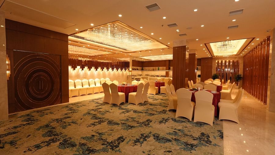 Well-lit banquet hall with elegant seating and carpeted flooring - Grand Plaza Lords Inn Jammu