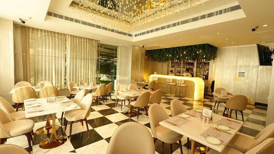 Elegant dining area with cushioned chairs and decorative ceiling - Grand Plaza Lords Inn Jammu