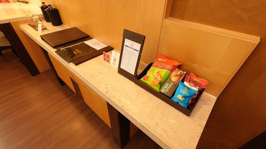 Hotel room desk with amenities like tea, coffee, and informational leaflets - Grand Plaza Lords Inn Jammu