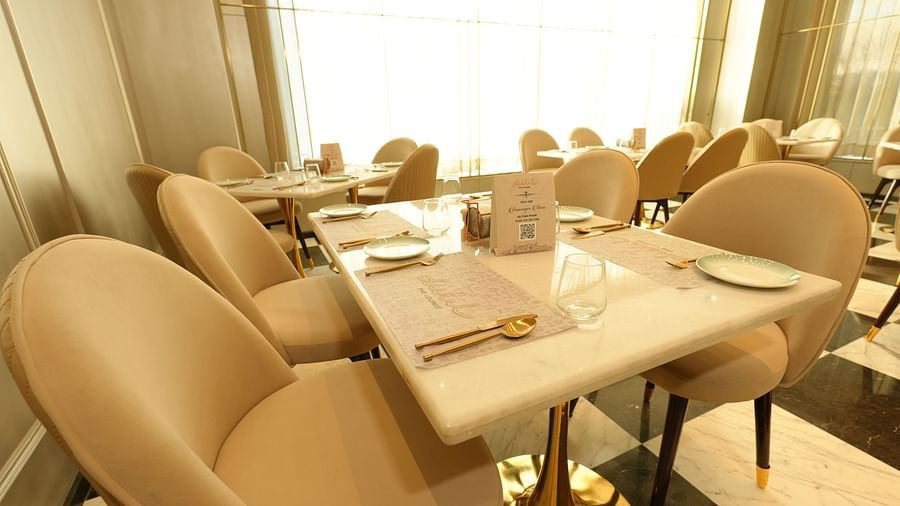 Cozy dining table set for two in a sunlit restaurant - Grand Plaza Lords Inn Jammu