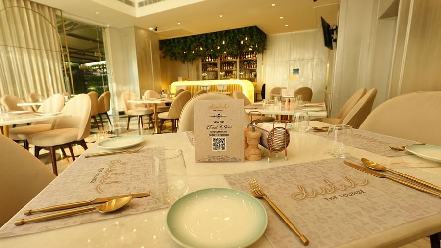 Close-up of a table setting with plate, menu, and cutlery - Grand Plaza Lords Inn Jammu