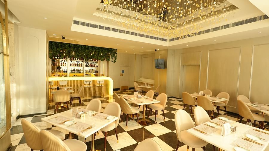 Bright restaurant space with cozy seating and contemporary lighting - Grand Plaza Lords Inn Jammu