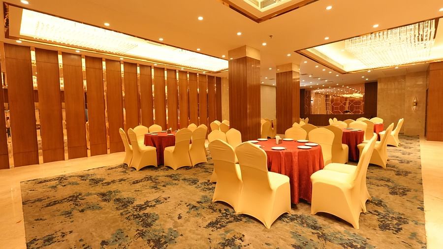 Elegant banquet hall with round tables and beige chairs - Grand Plaza Lords Inn Jammu