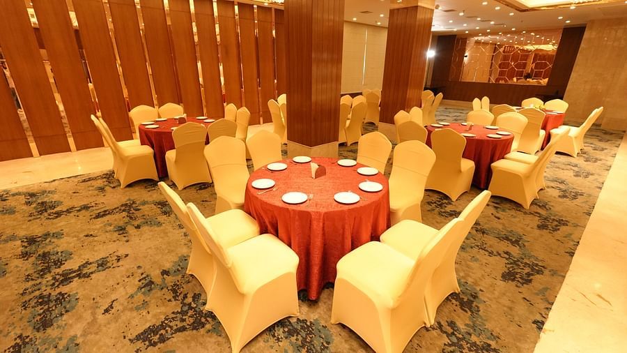 Elegant banquet hall with round tables and beige chairs - Grand Plaza Lords Inn Jammu