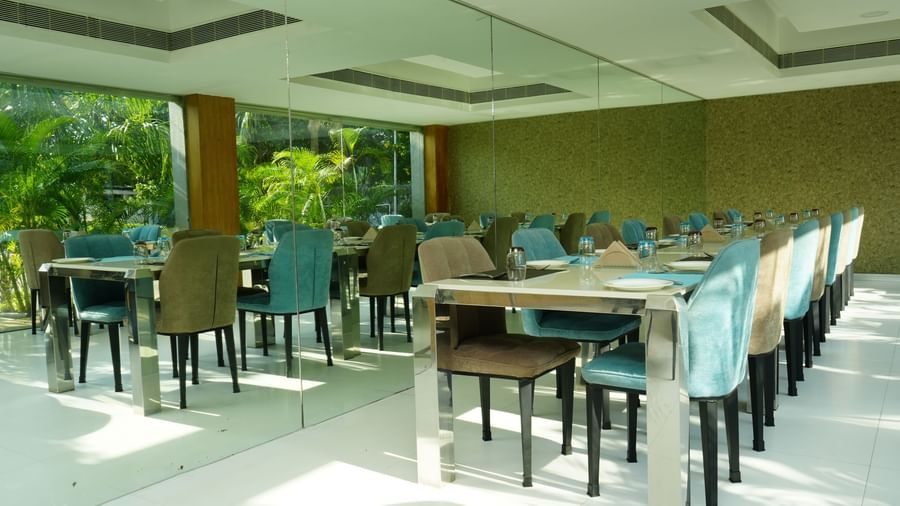 A spacious restaurant dining area with neatly arranged tables and chairs at Grande Bay Resort & Spa.