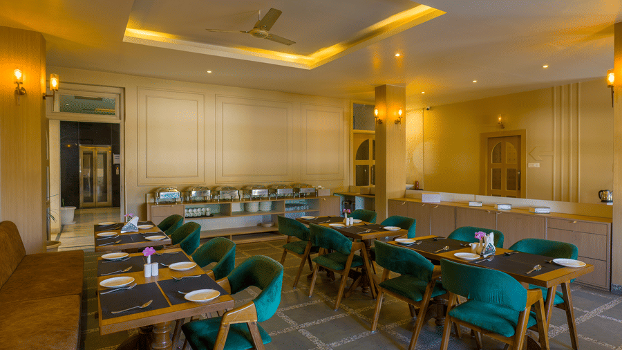 The dining area of Amaya Restaurant looking towards the entrance with set tables ready for guests at Grassfield Riveria Resort.