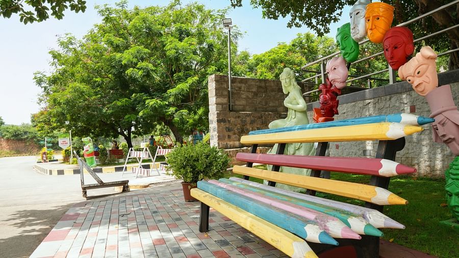Pencil-shaped seats surrounded by trees at Greens Inn - Creative Seating in Hyderabad.
