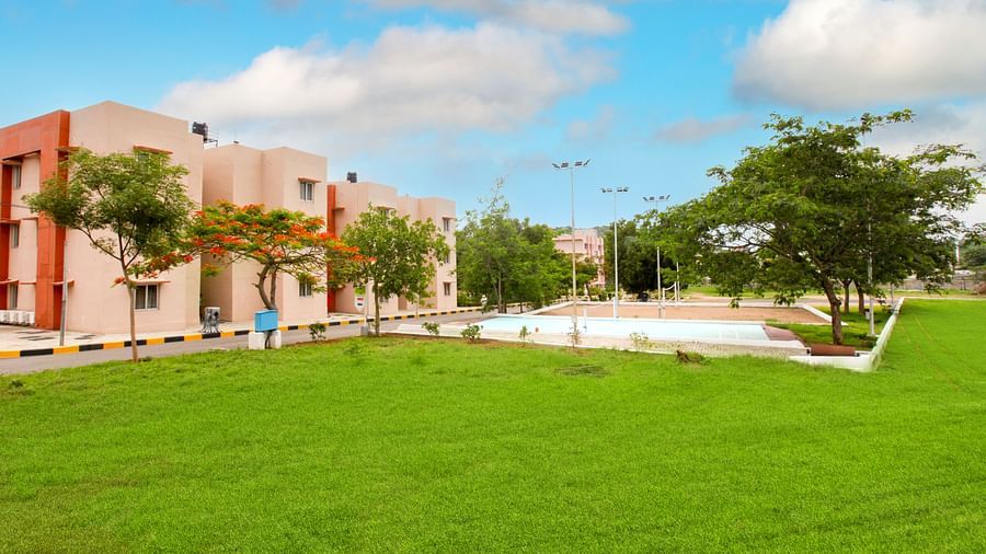 Panoramic view of Greens Inn with a lawn in front of it - Spacious Hotel Grounds in Hyderabad.