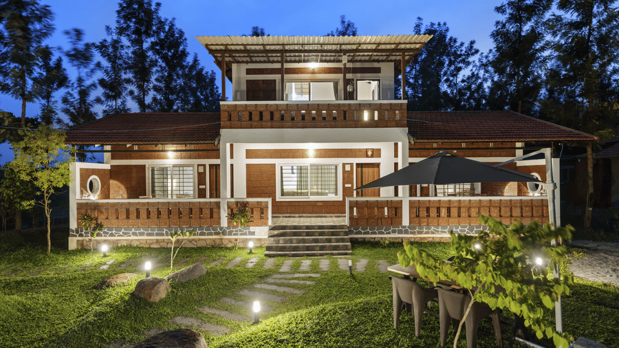 Exterior of Hatti Eden Coorg showcasing the resort's charming architecture, landscaped gardens, outdoor seating and serene surroundings, creating a welcoming retreat amidst nature.