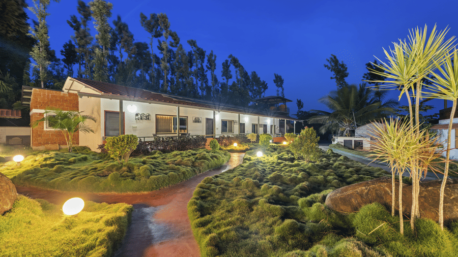 Hatti Eden Coorg showcasing beautifully landscaped gardens, illuminated walking paths, elegant cottages and lush greenery, offering a serene and welcoming retreat amidst the natural beauty of Coorg.