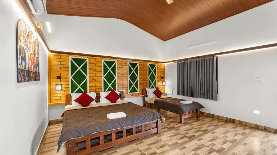 Family Room With Garden View 2 at Hatti Eden Coorg with one king size bed, one single bed, wooden interiors, decorative accent wall, and large garden-facing windows.