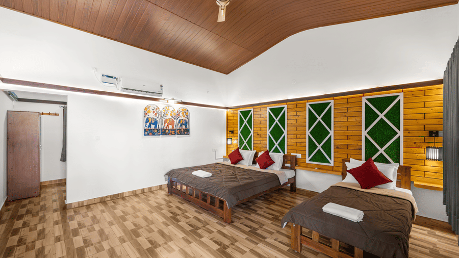 Spacious Family Room With Garden View 2 at Hatti Eden Coorg featuring one king size bed, one single bed, a wooden ceiling, air conditioning, and contemporary décor.