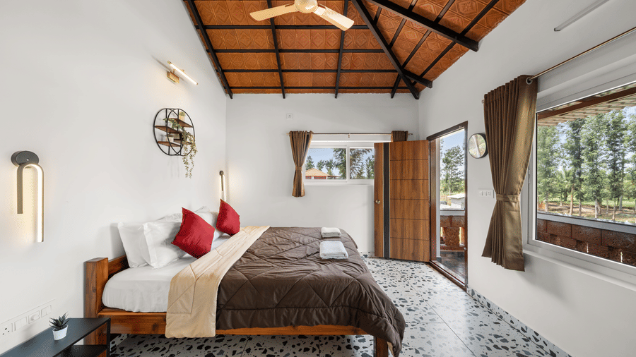 Room with Balcony at Hatti Eden Coorg featuring a comfortable bed, elegant interiors, large windows, balcony access and scenic nature views for a relaxing stay.