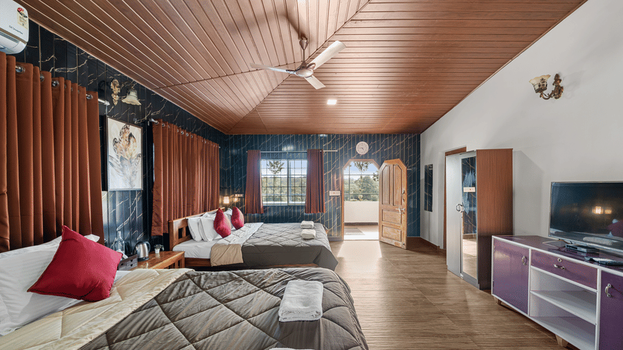 Spacious Quad Room With Forest View featuring wooden ceilings and TV console, Hatti Eden Coorg.
