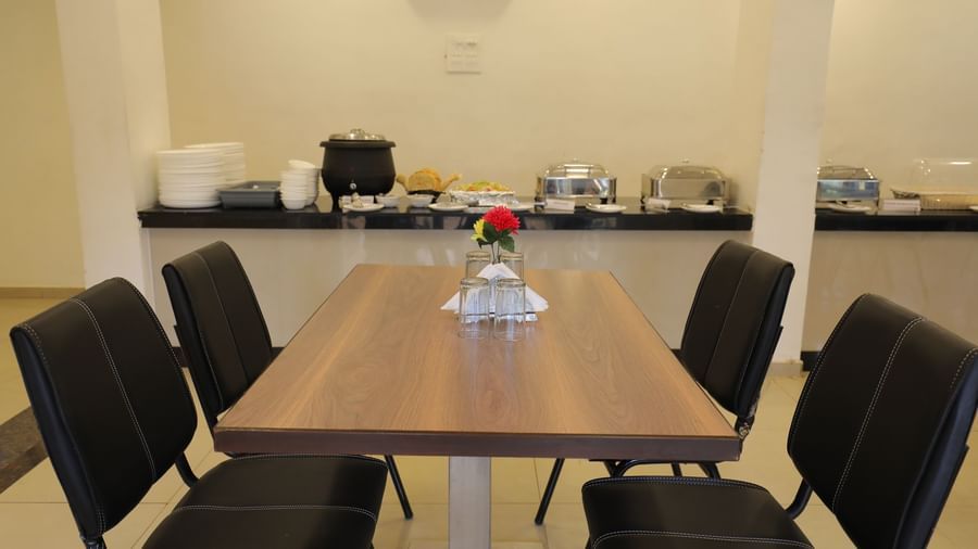 Close up of a dining table at Darbar Restaurant, with the buffet section in the background.