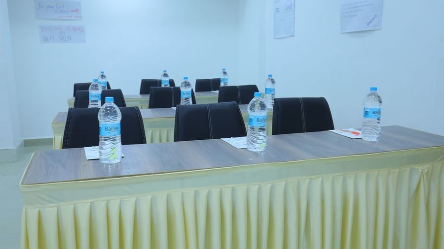 A close up of tables placed in classroom arrangement, with water bottles, stationary, in Olive banquet hall of Highland Resort.